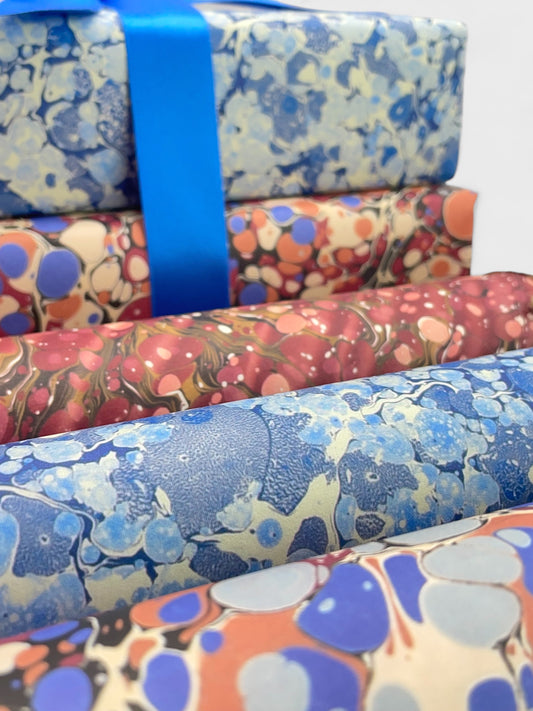 rolls of marbled papers in colours of blue, pink and burgandy