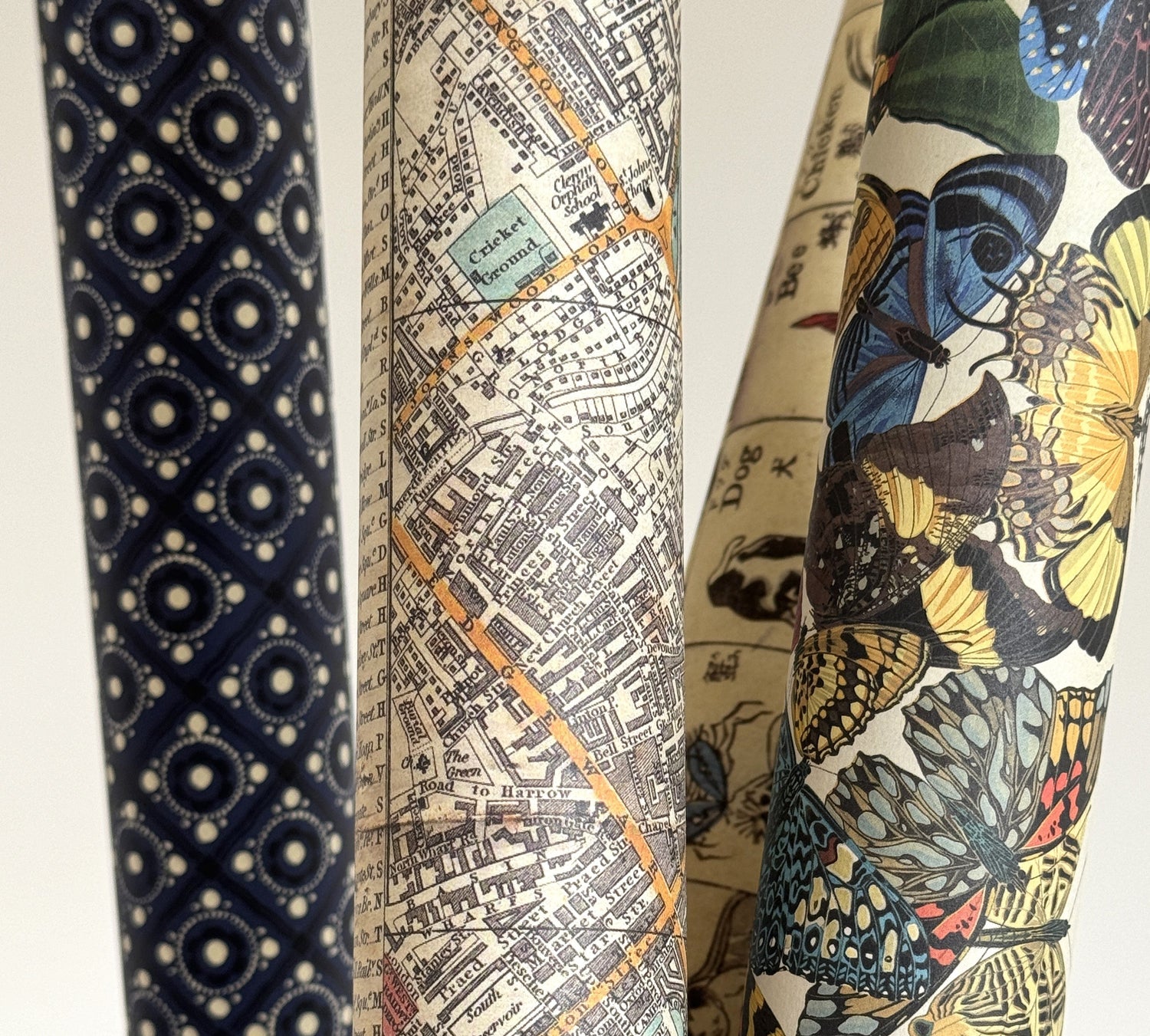 rolls of poster wrap, with designs of a map and butterflies