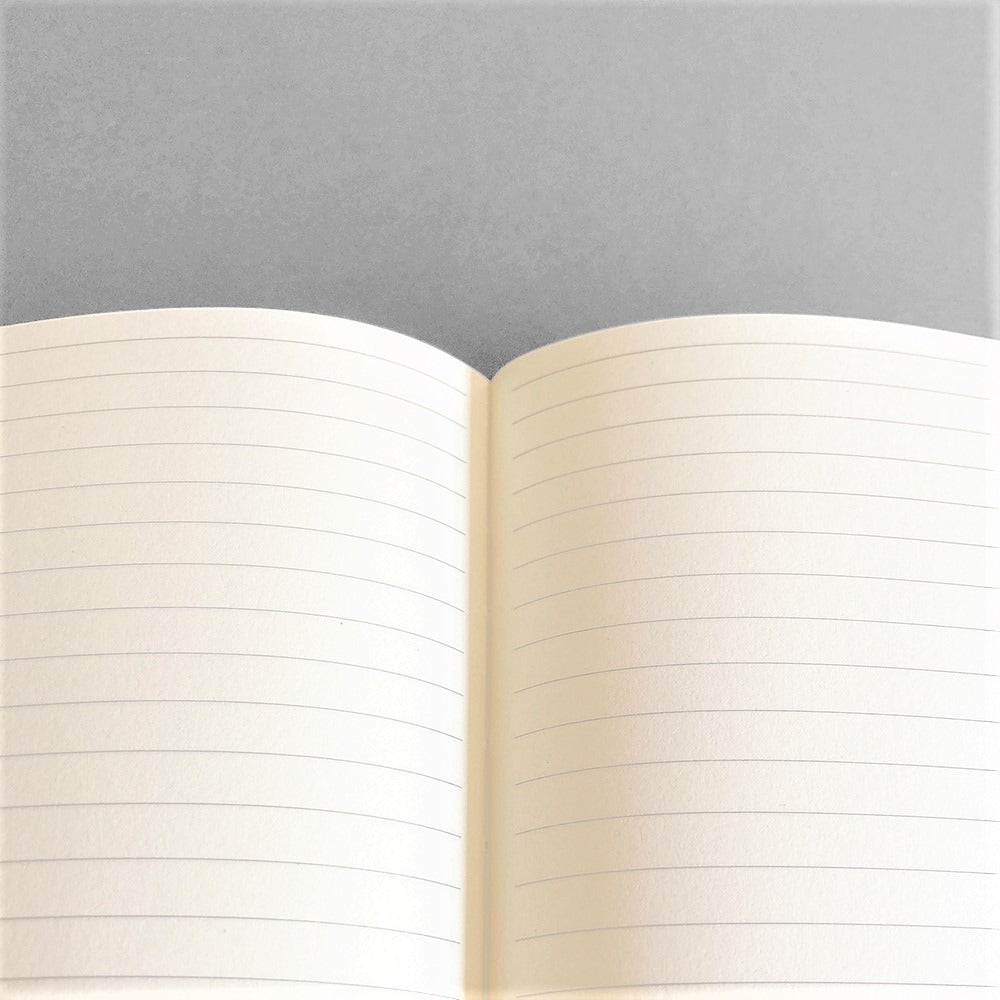 A lined notebook with striped block colours in orange, rose and navy by Amaretti Design. Lined pages