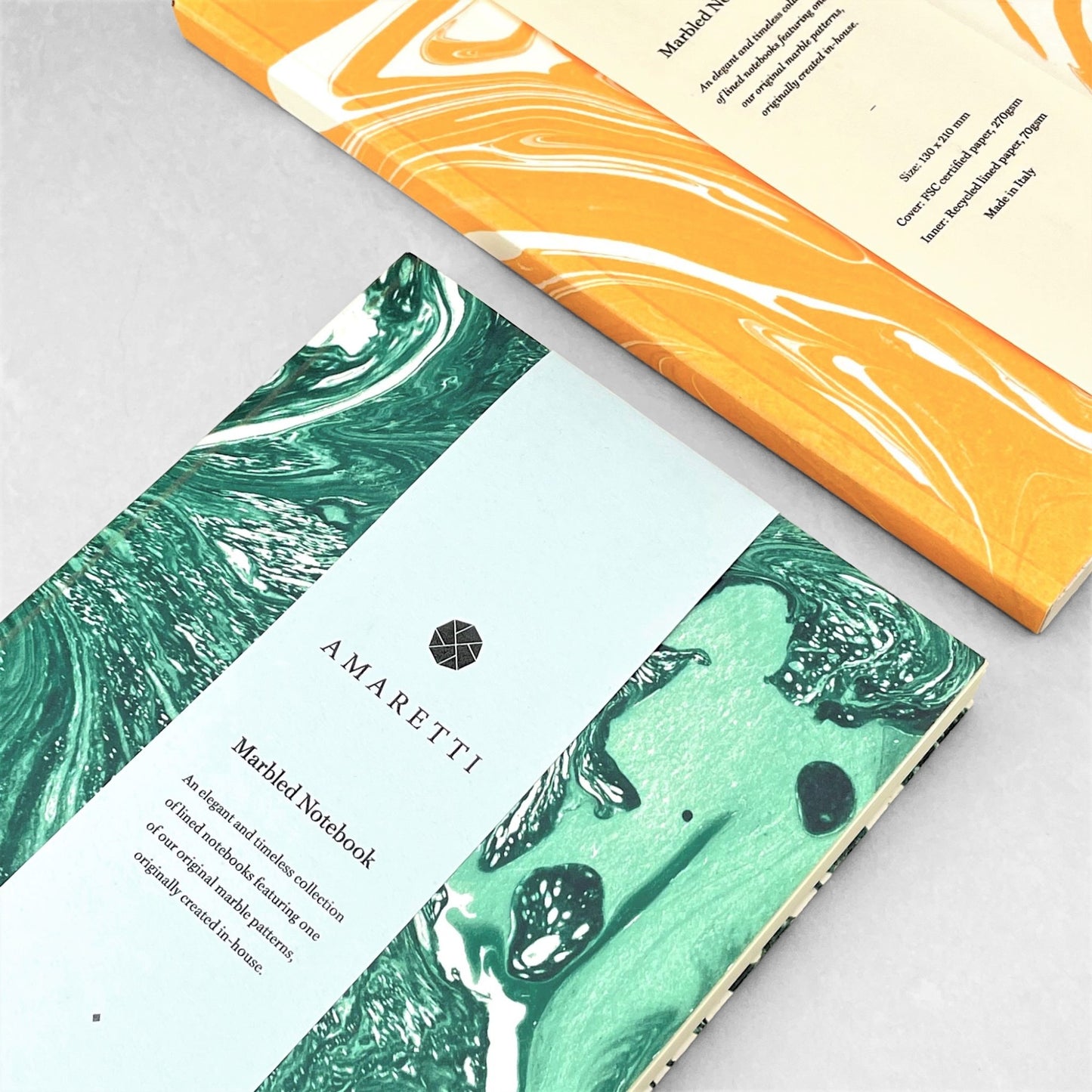 A lined notebook with green marble printed softcover by Amaretti Design