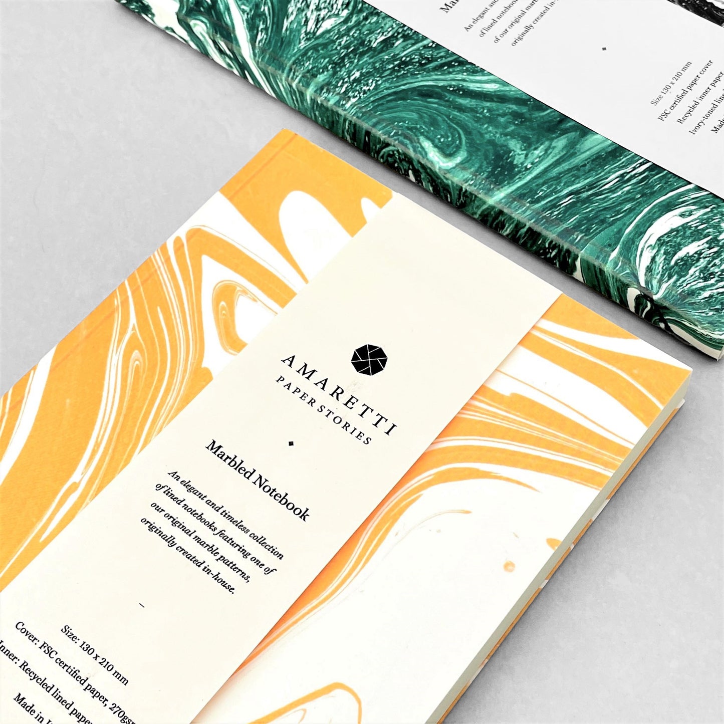 A lined notebook with yellow marble printed softcover by Amaretti Design