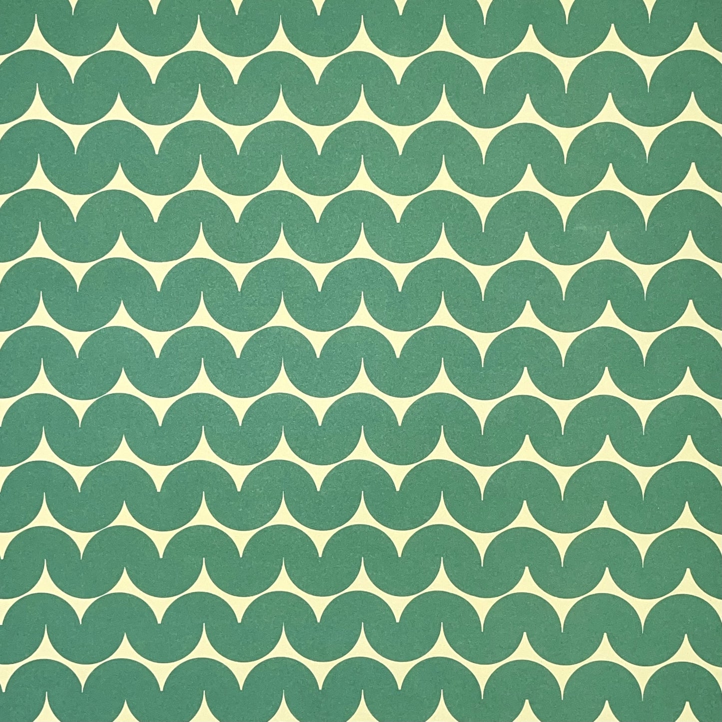 wrapping paper by Anne Davison Studio. Bold green wiggle lines with a retro vibe on beige backdrop.