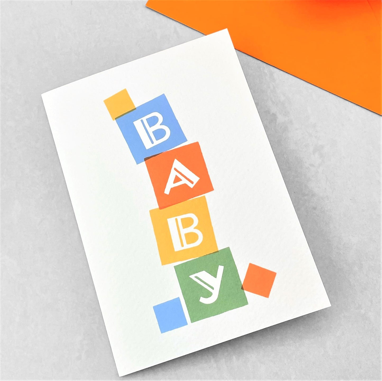 New baby greetings card with a pile of multicolour baby blocks, by Ariana Martin