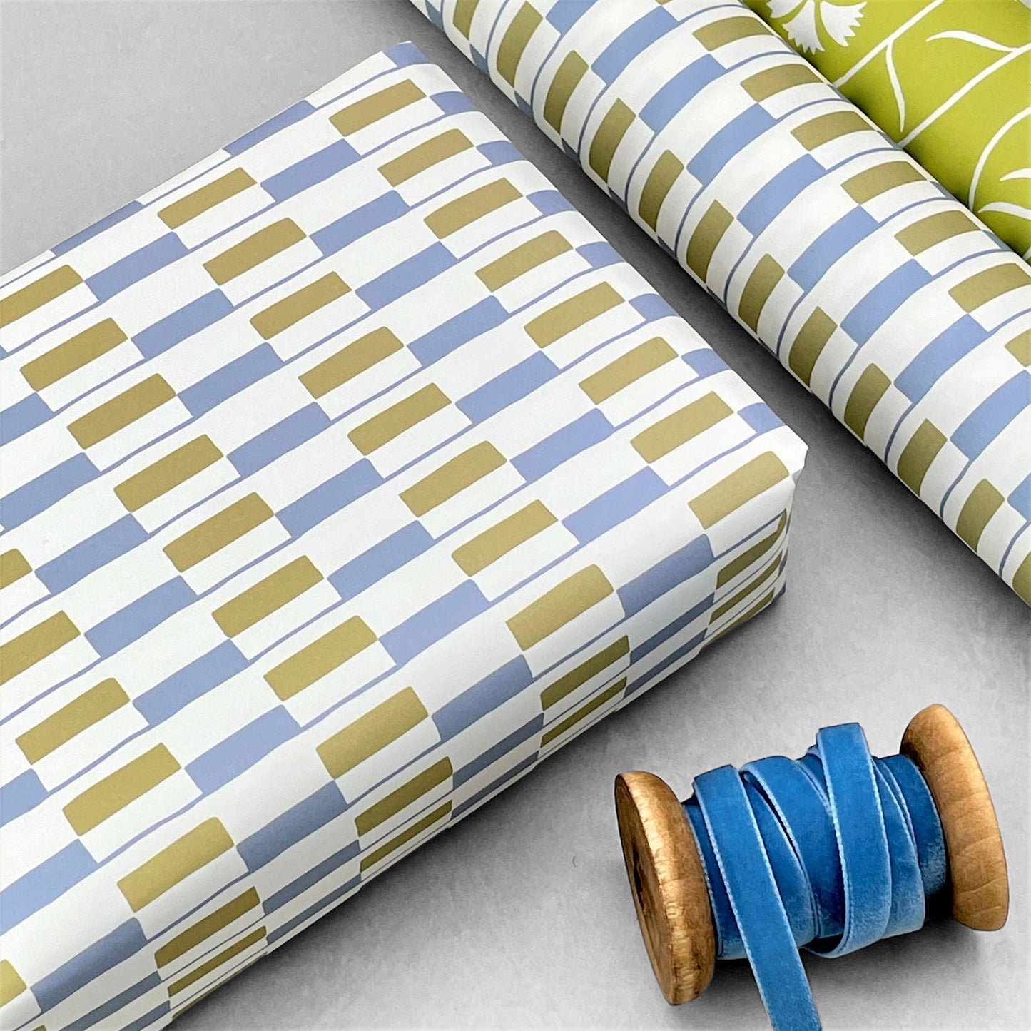 patterned paper gift wrap with a geometric blue and green rectangular design on white background, by Ariana Martin