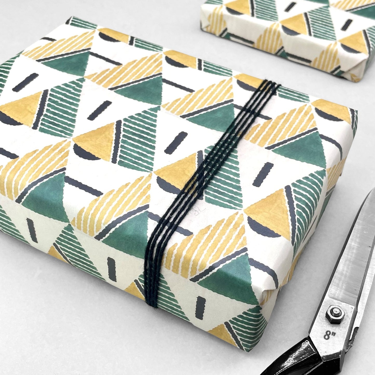 wrapping paper with yellow and green triangular geometry repeat design by Artisan Design. Design Silver Studios