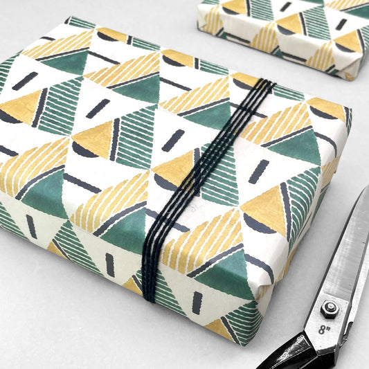 wrapping paper with yellow and green triangular geometry repeat design by Artisan Design. Design Silver Studios