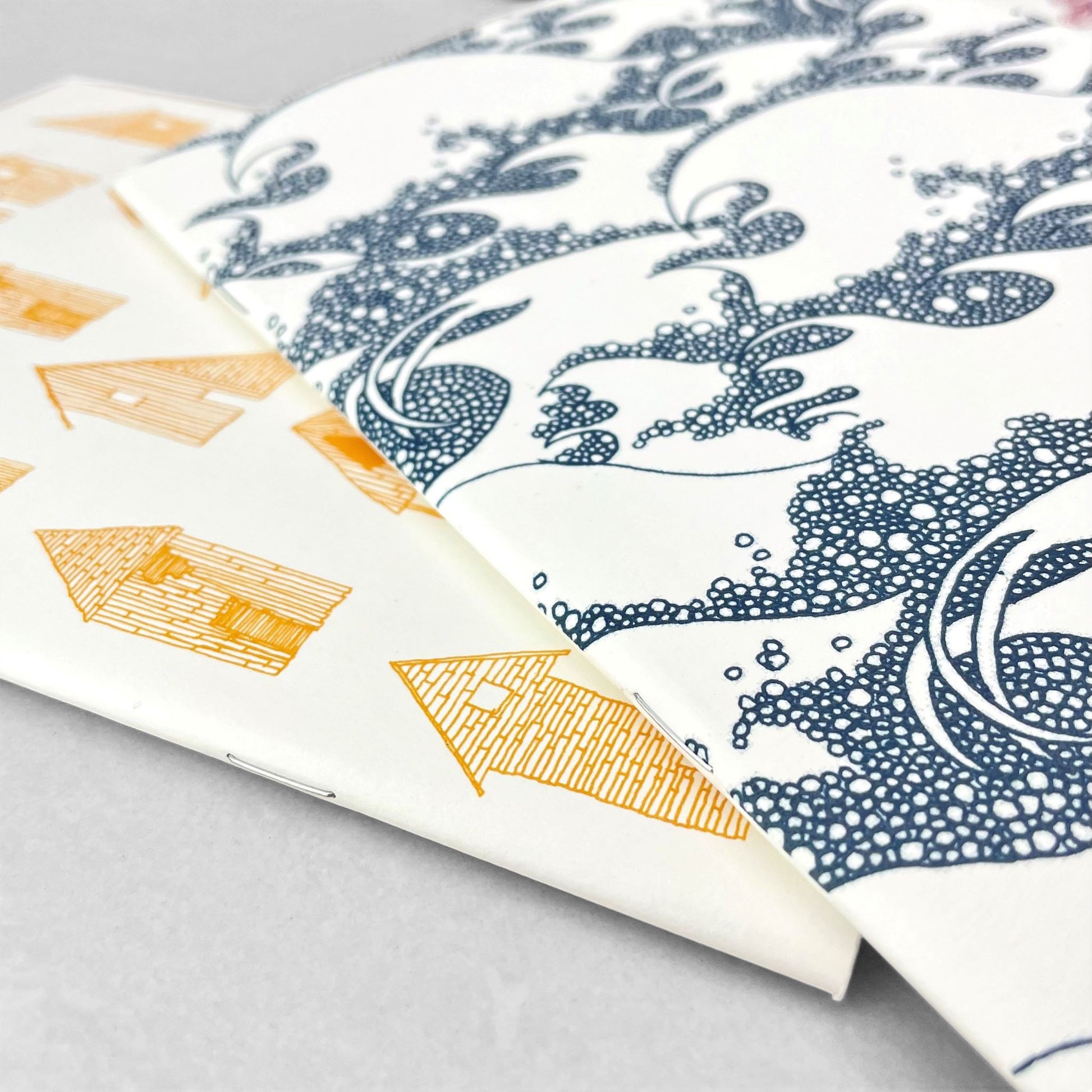 A5 slimline notebook with a delicate illustration of waves in dark blue on a ivory backdrop by Parisian brand Atelier Mouti