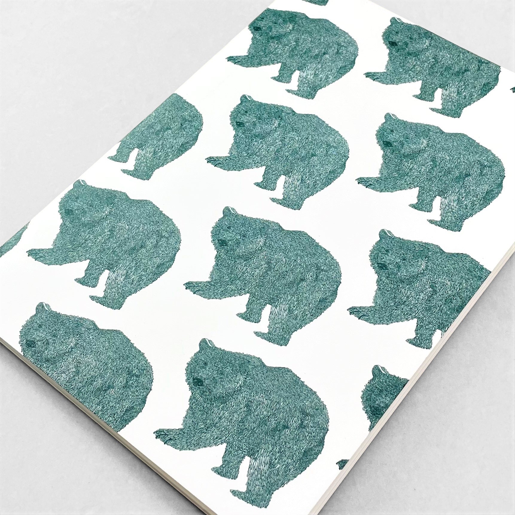A5 slimline notebook with a delicate illustration of bears in teal on a ivory backdrop by Parisian brand Atelier Mouti
