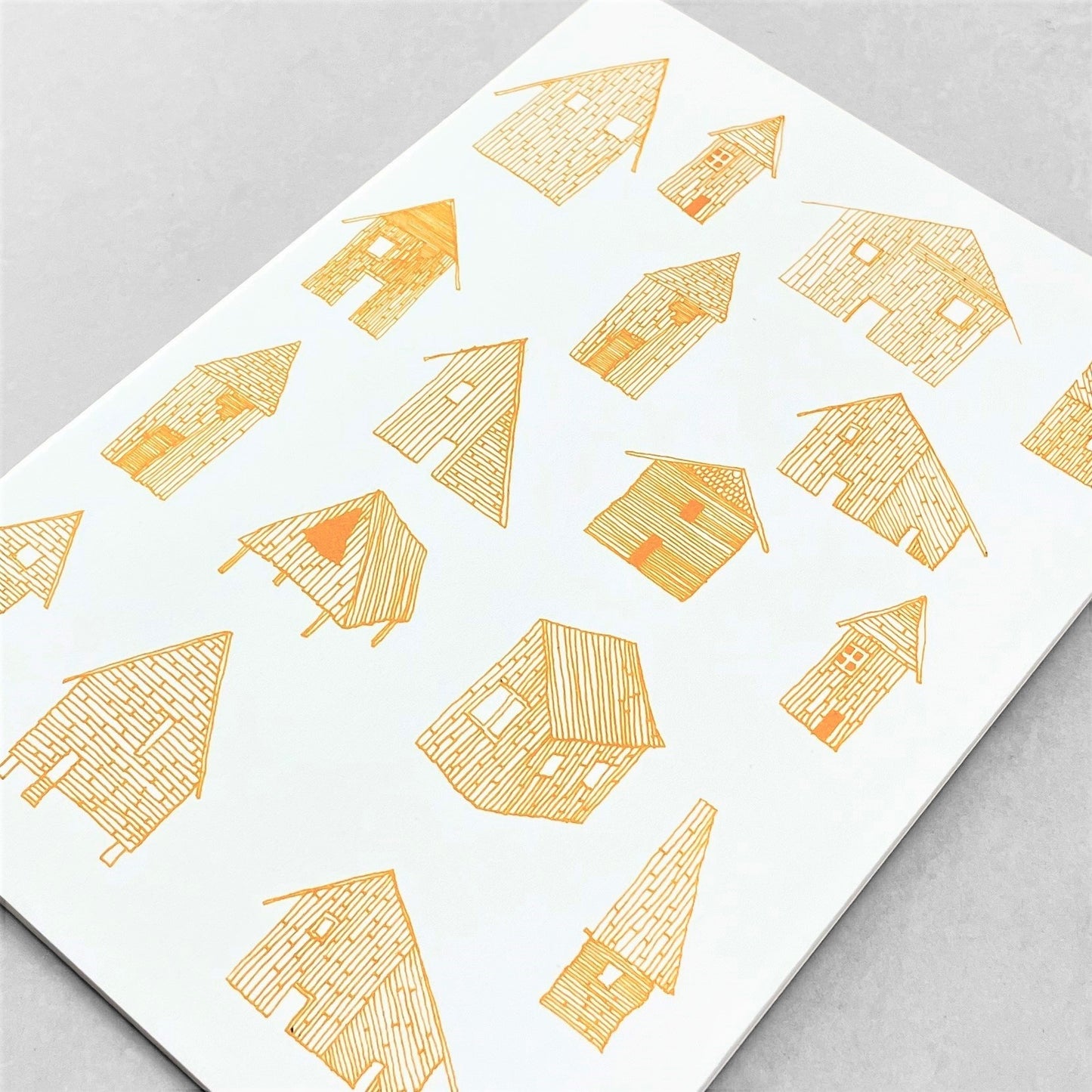 A5 slimline notebook with a delicate illustration of little houses in mustard yellow on a ivory backdrop by Parisian brand Atelier Mouti