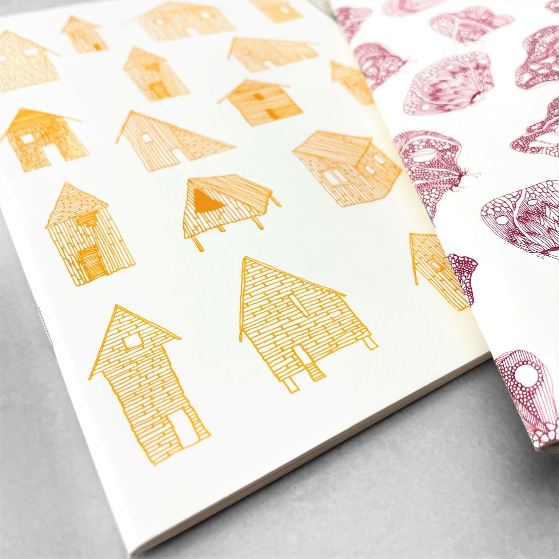 A5 slimline notebook with a delicate illustration of little houses in mustard yellow on a ivory backdrop by Parisian brand Atelier Mouti