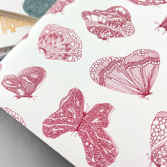 A5 slimline notebook with a delicate illustration of butterflies in burgundy on a ivory backdrop by Parisian brand Atelier Mouti