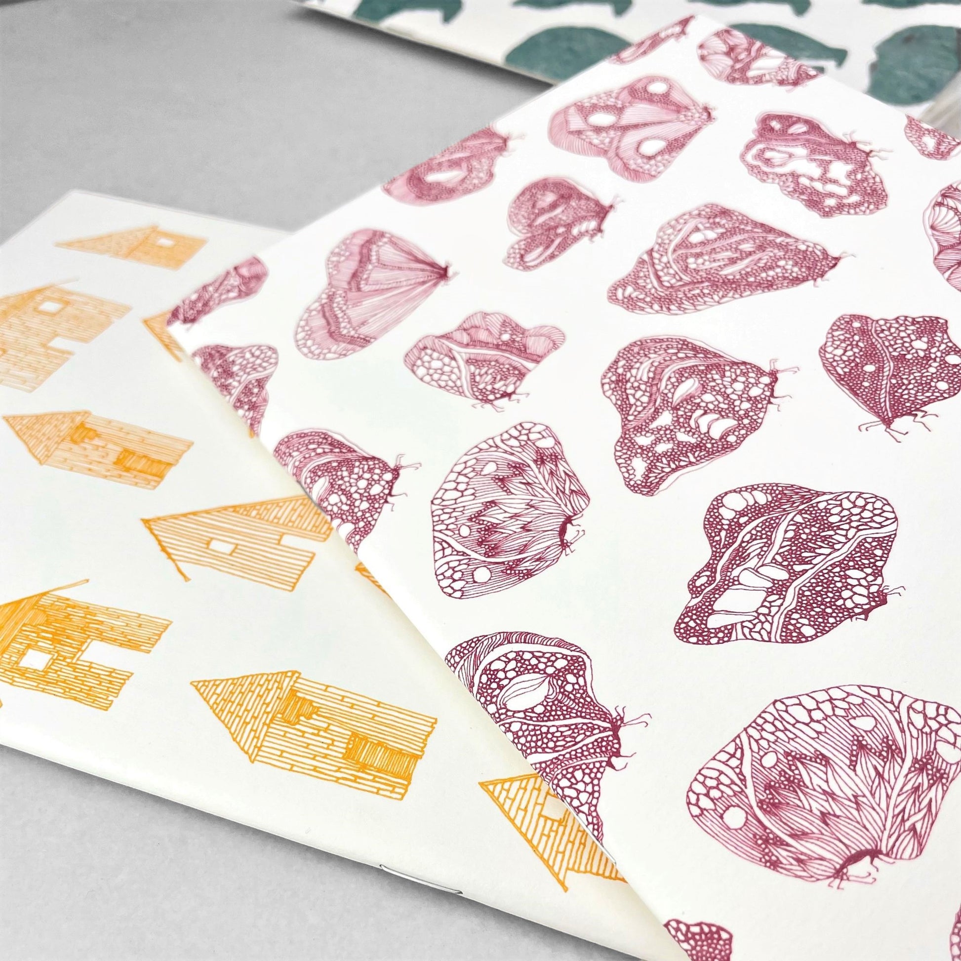 A5 slimline notebook with a delicate illustration of butterflies in burgundy on a ivory backdrop by Parisian brand Atelier Mouti