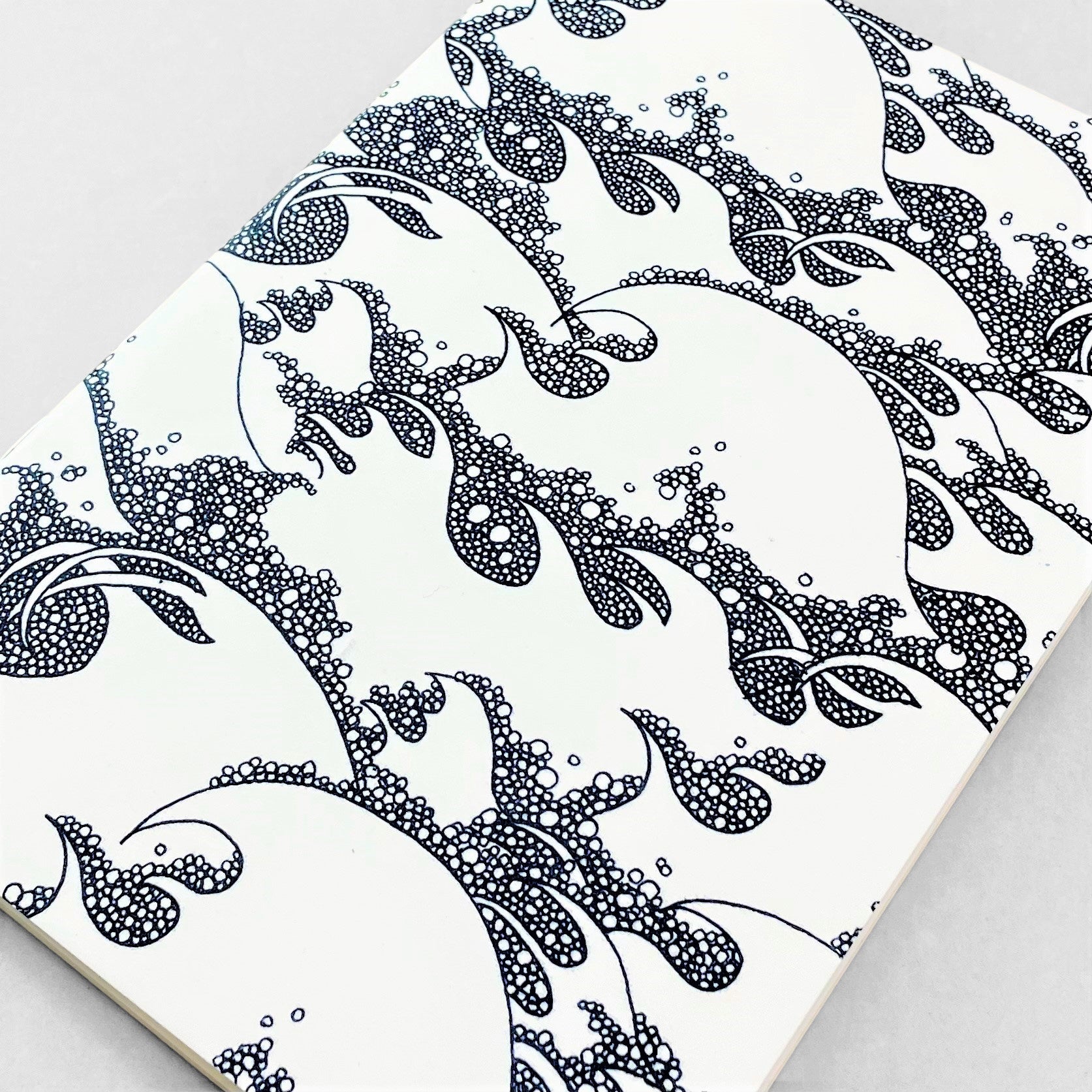 A5 slimline notebook with a delicate illustration of waves in dark blue on a ivory backdrop by Parisian brand Atelier Mouti