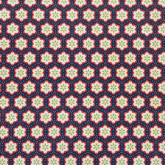 Patterned paper with red, green, and white stars on a blue background