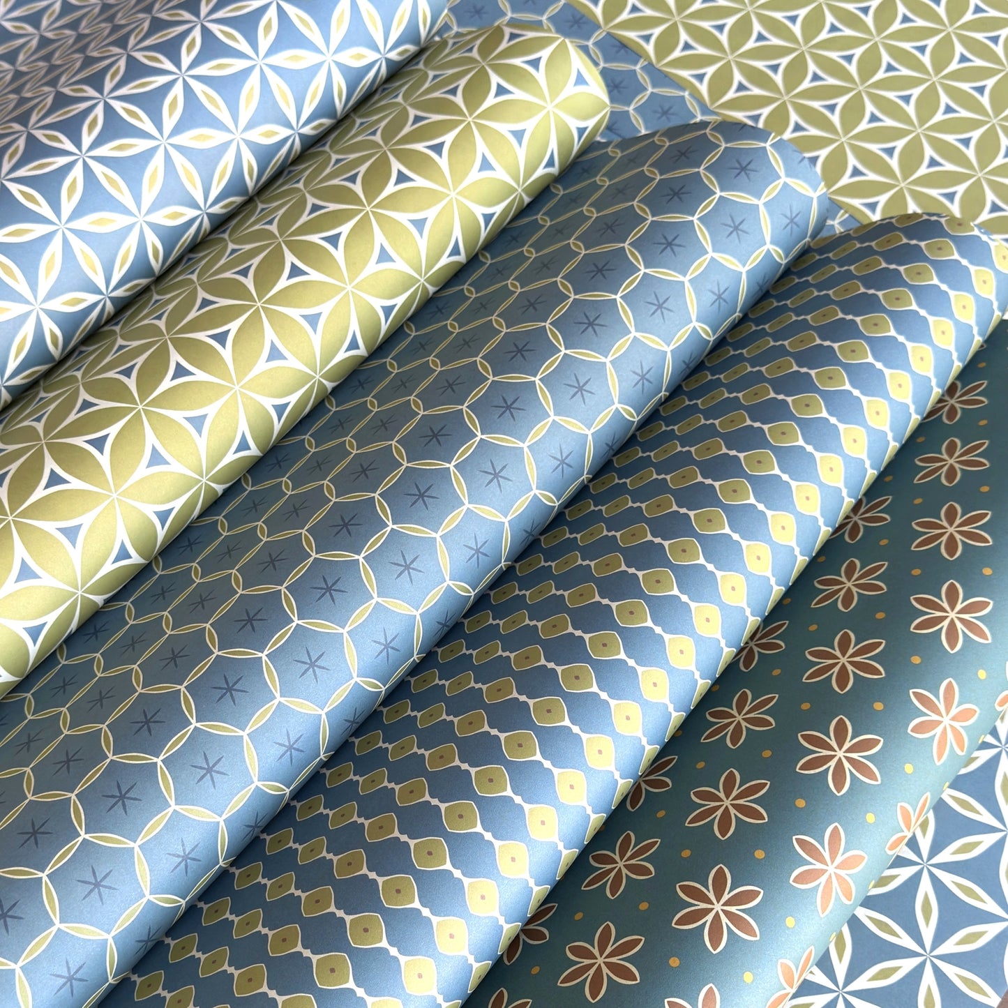 five different geometric wrapping papers in lime green and teal blue