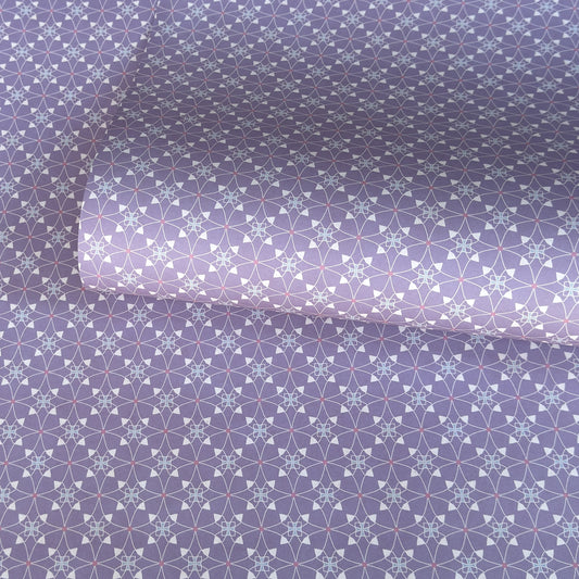 Patterned wrapping paper with geometric design on a purple background