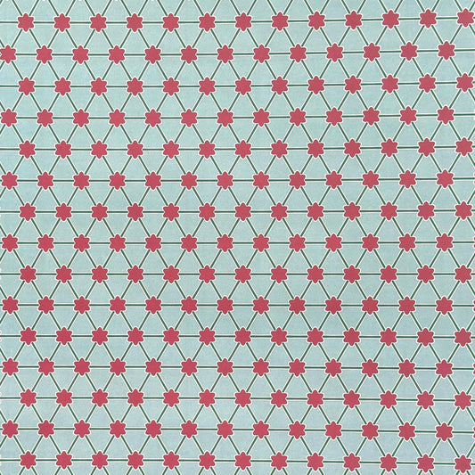 Patterned paper with pink floral shapes on a light blue background