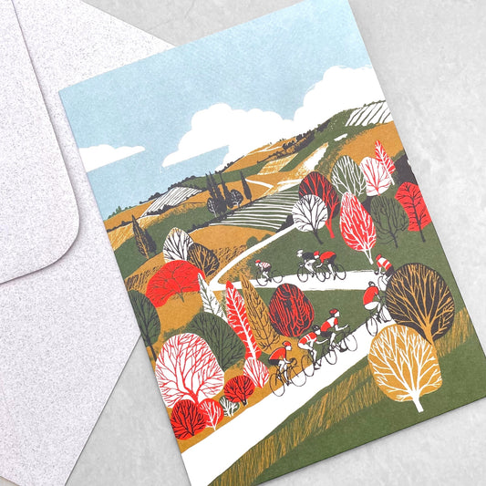 greetings card showing cyclists on a winding hilly road by Canns Down Press