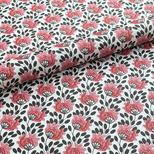 wrapping paper with a repeat design of pink flowers, black seedheads on white