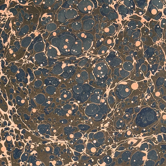 A printed marble design wrapping paper in tones of brown, blue and soft coral pink.