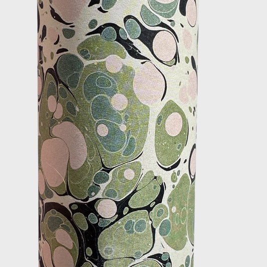 marbled printed wrapping paper with spot design in moss green, pale pink on a soft green. close up