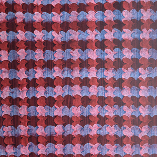 a sheet of wrapping paper with an abstract block print in dark red, pink and blue