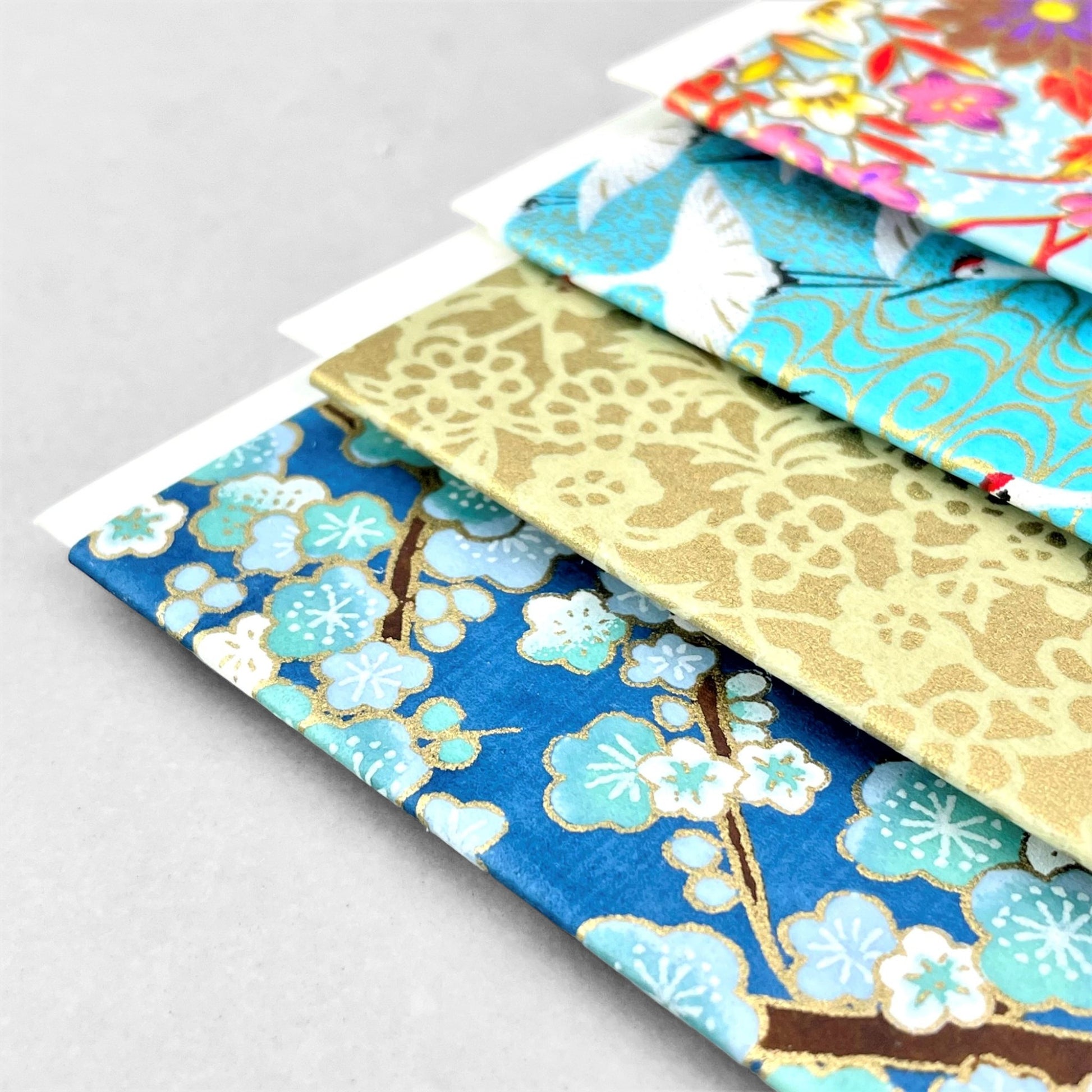 japanese silk-screen printed greetings card with a pattern of pale blue and white blossom on a blue backdrop by Esmie