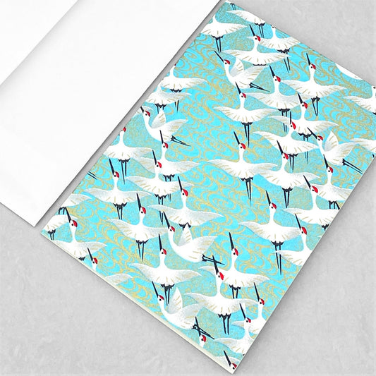 japanese silk-screen printed greetings card with a repeat diagonal pattern of white cranes on an aqua backdrop by Esmie
