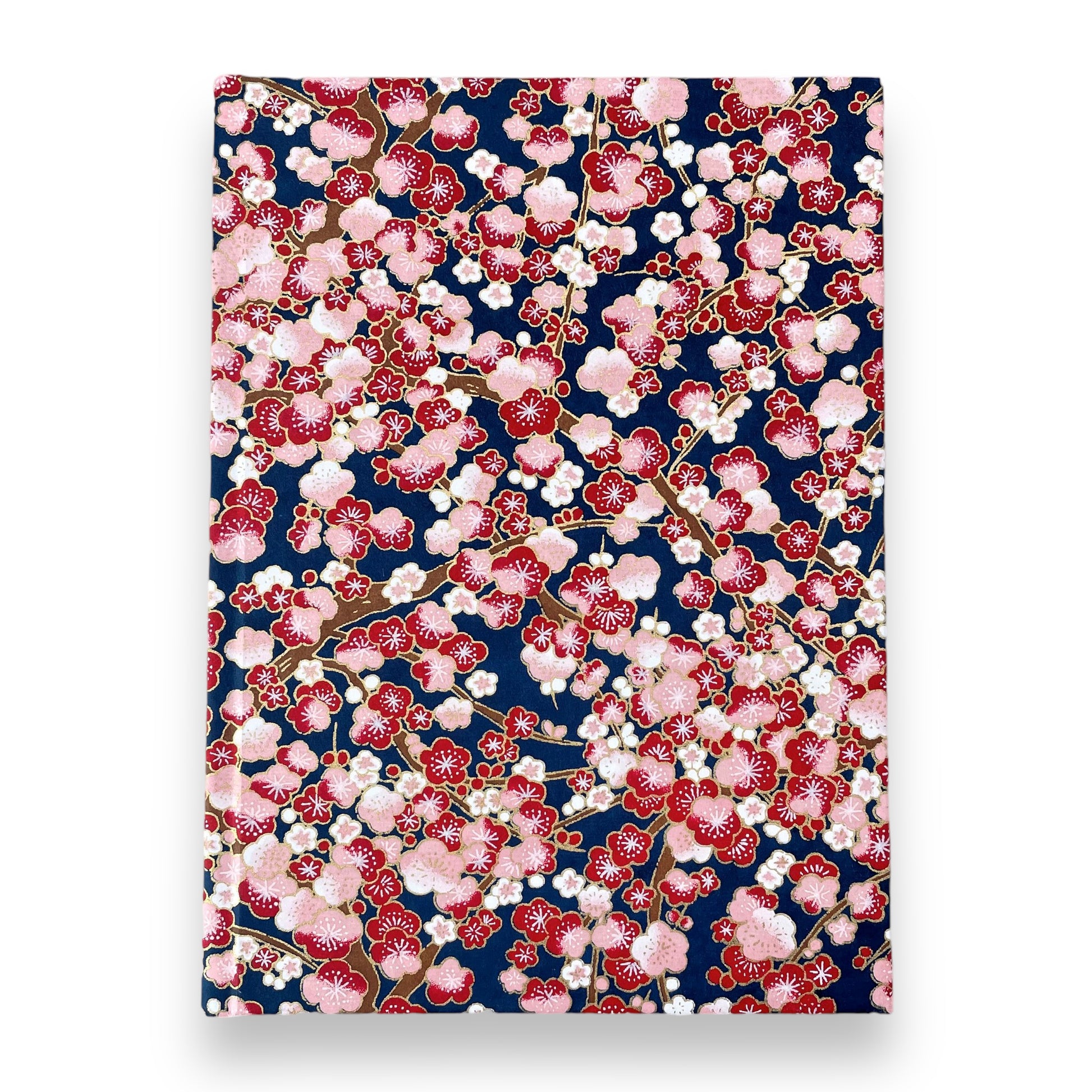 hardback A5 plain notebook with cover made of japanese silkscreen chiyogami paper. Pink and burgundy cherry blossom design on dark blue backdrop by Esmie