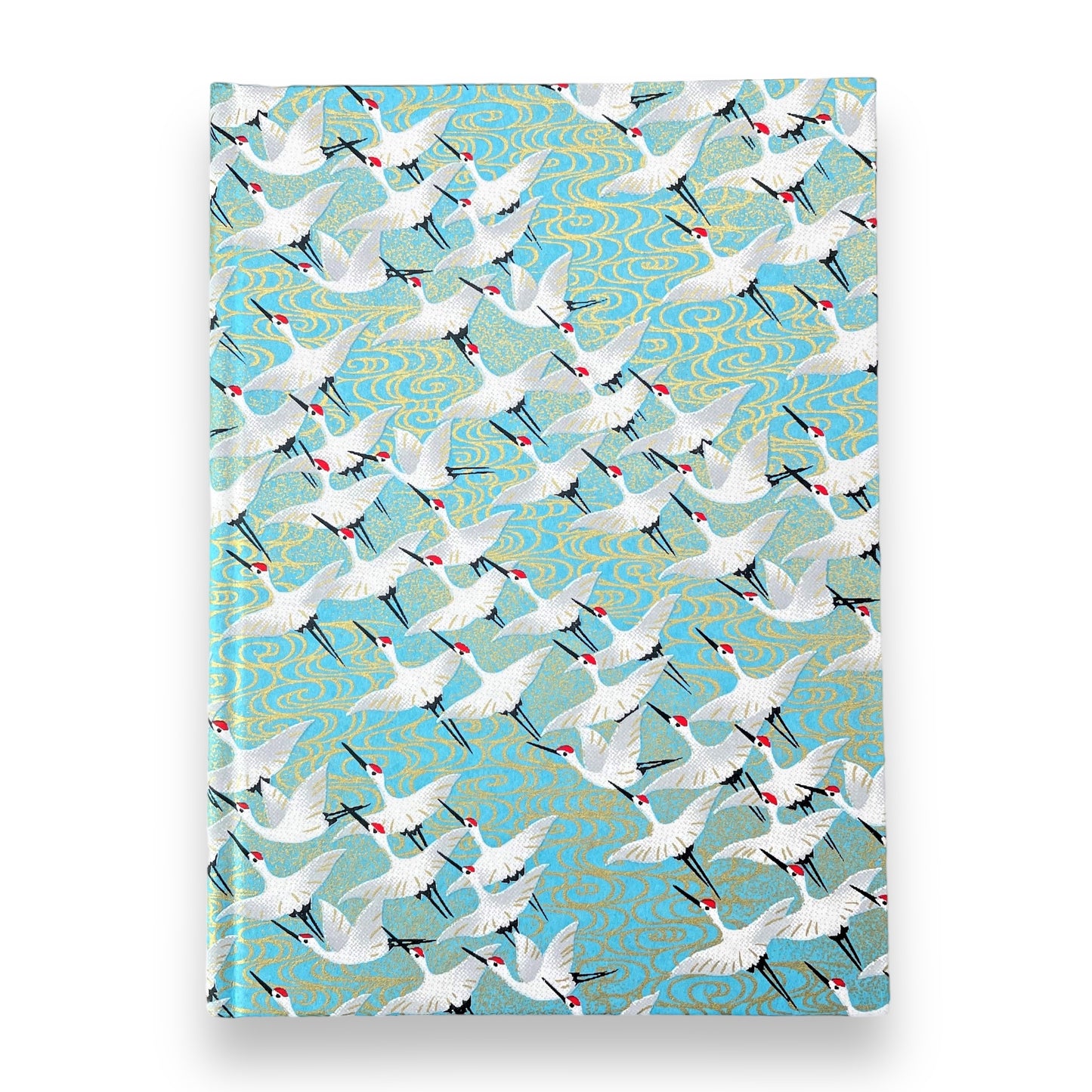 hardback A5 plain notebook with cover made of japanese silkscreen chiyogami paper. White cranes in flight on a pale blue background by Esmie