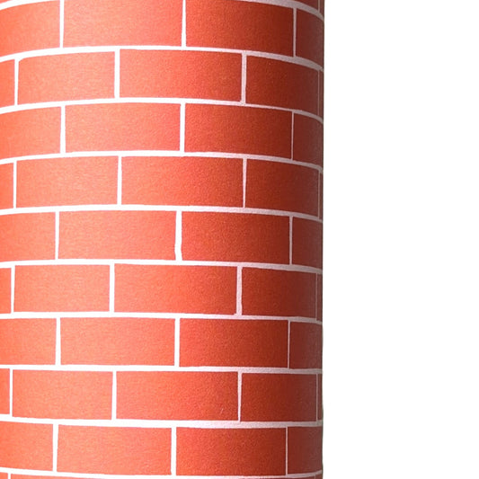 a sheet of gift wrap with a small brick design in rich red and pink