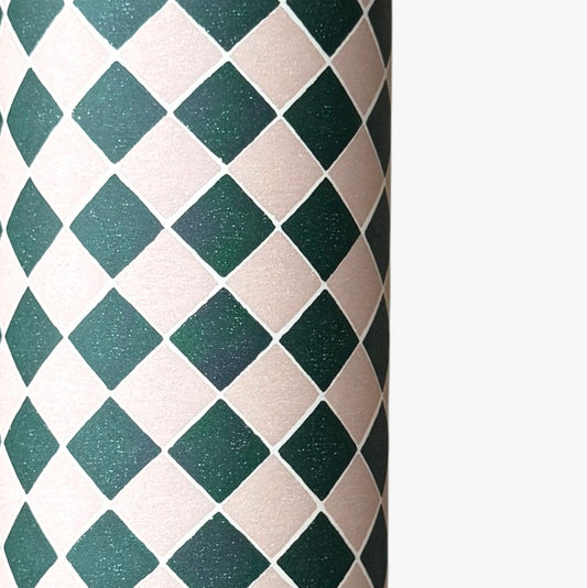 a sheet of wrapping paper with a quarry tile chequerboard design in very dark green and pale pink