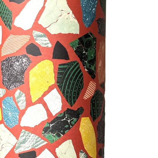 Colorful terrazzo pattern on a red background. A sheet of wrapping paper.