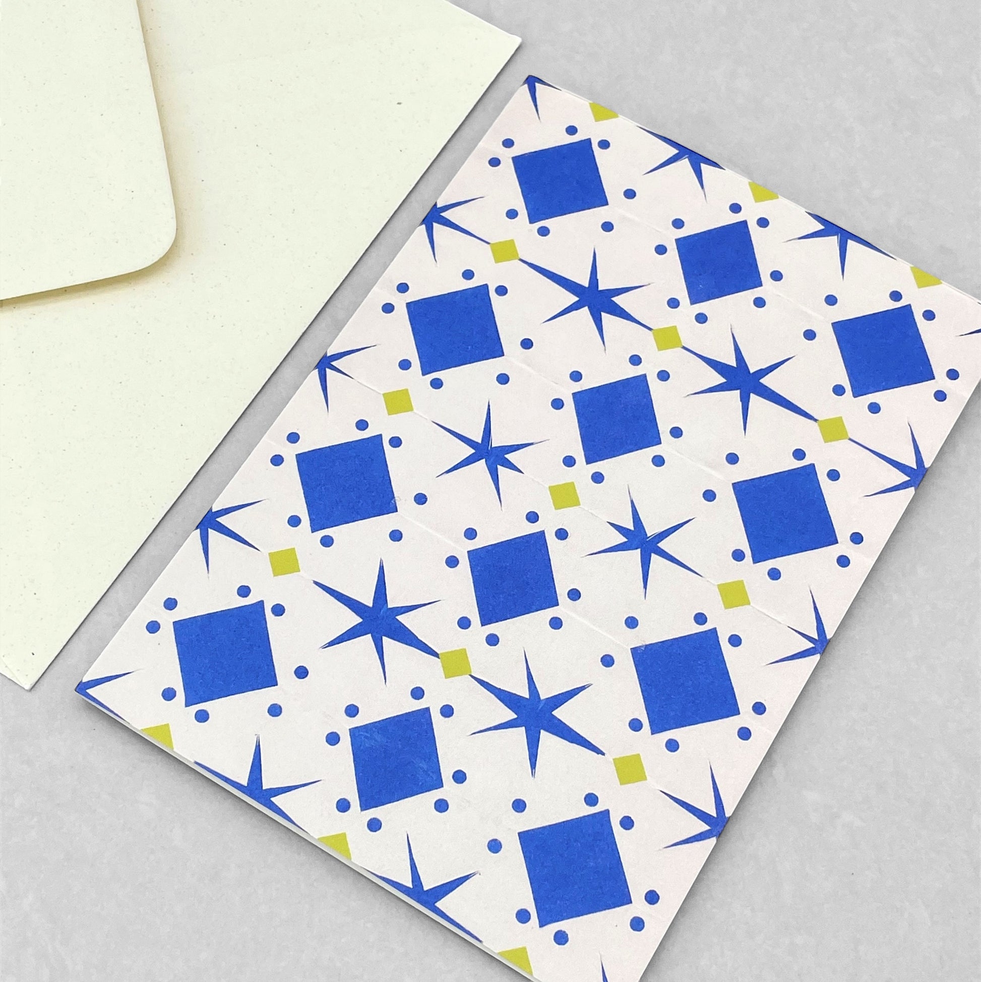 greetings card with cream background and blue and yellow papercut repeat pattern by Hadley Paper Goods