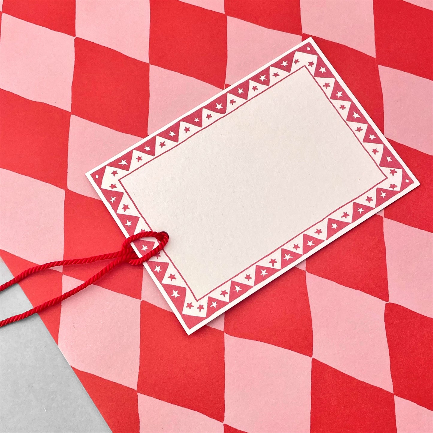 wrapping paper with large diamond repeat pattern in red and pink by Heather Evelyn