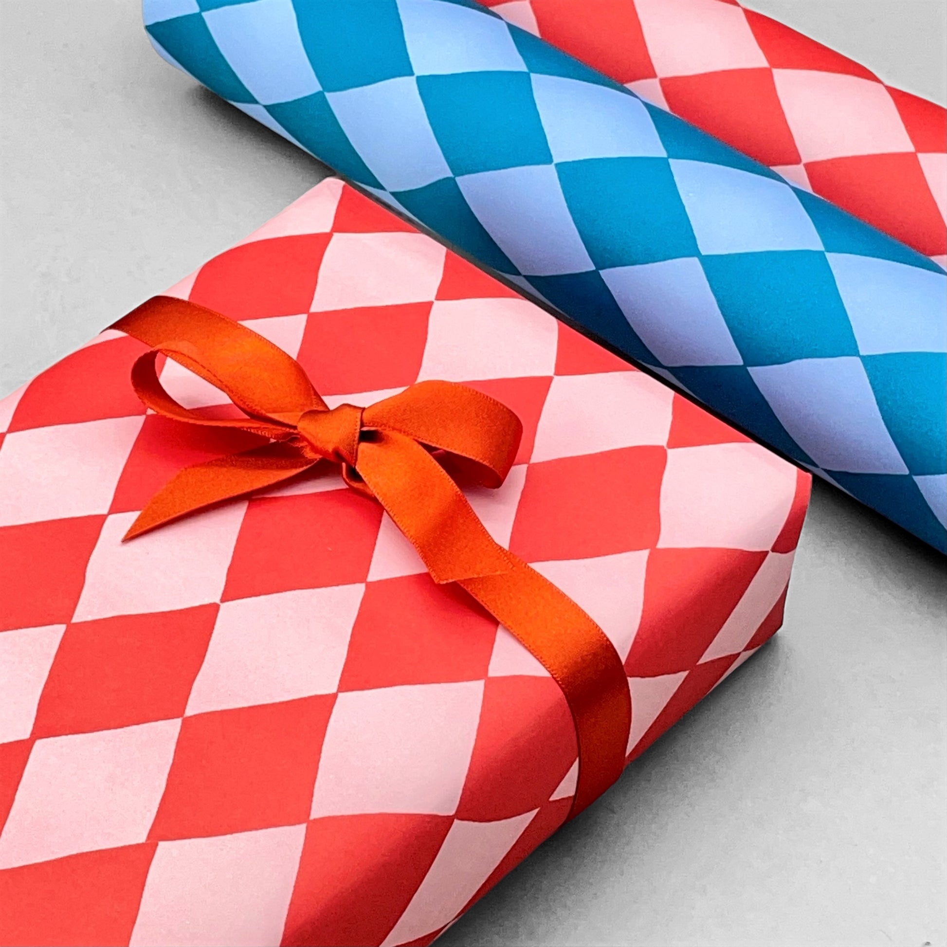 wrapping paper with large diamond repeat pattern in red and pink by Heather Evelyn