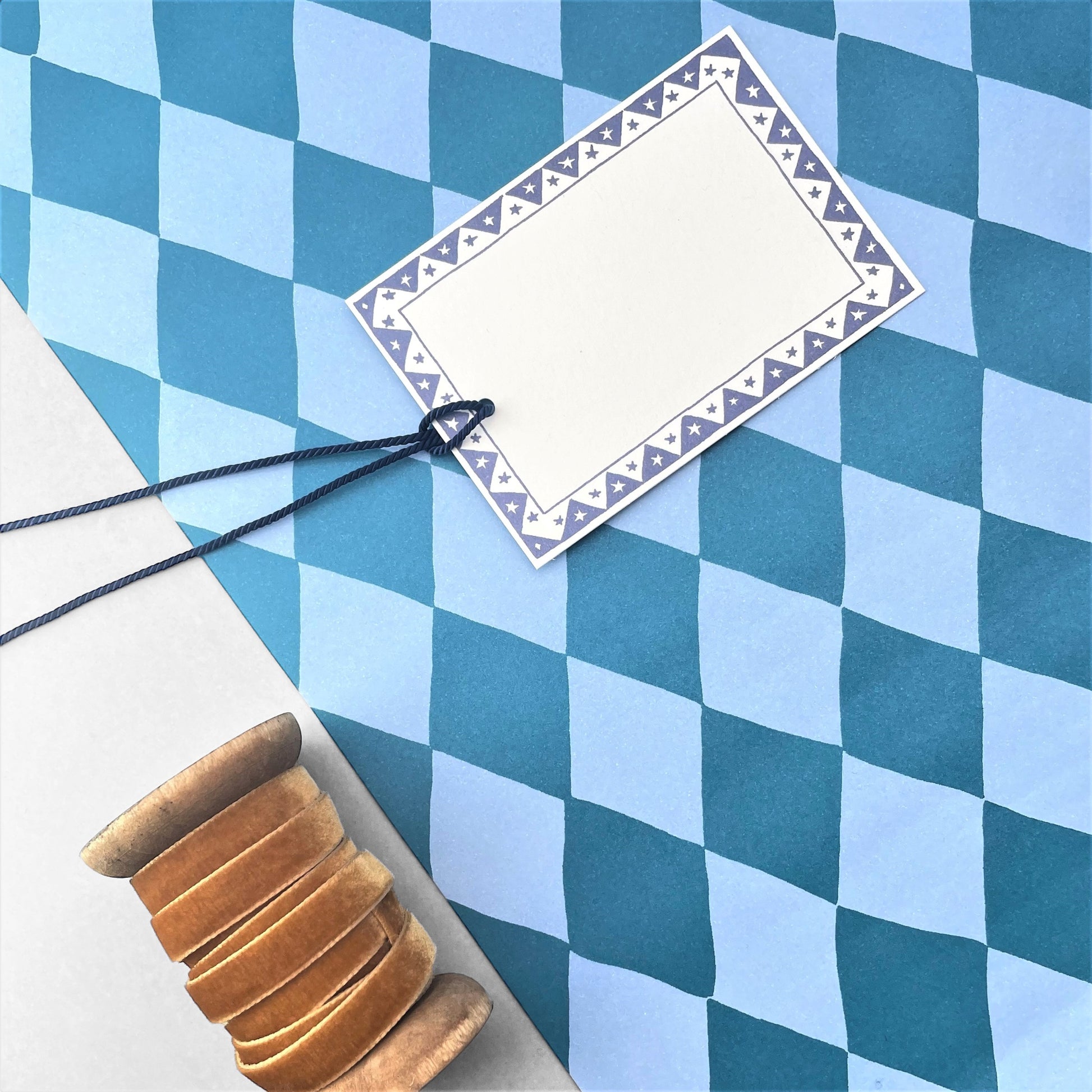 wrapping paper with large diamond repeat pattern in light and dark teal-blue by Heather evelyn