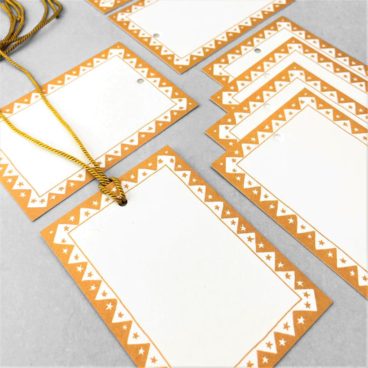 White rectangular gift tag with dark yellow star pattern border and yellow cord by Heather Evelyn