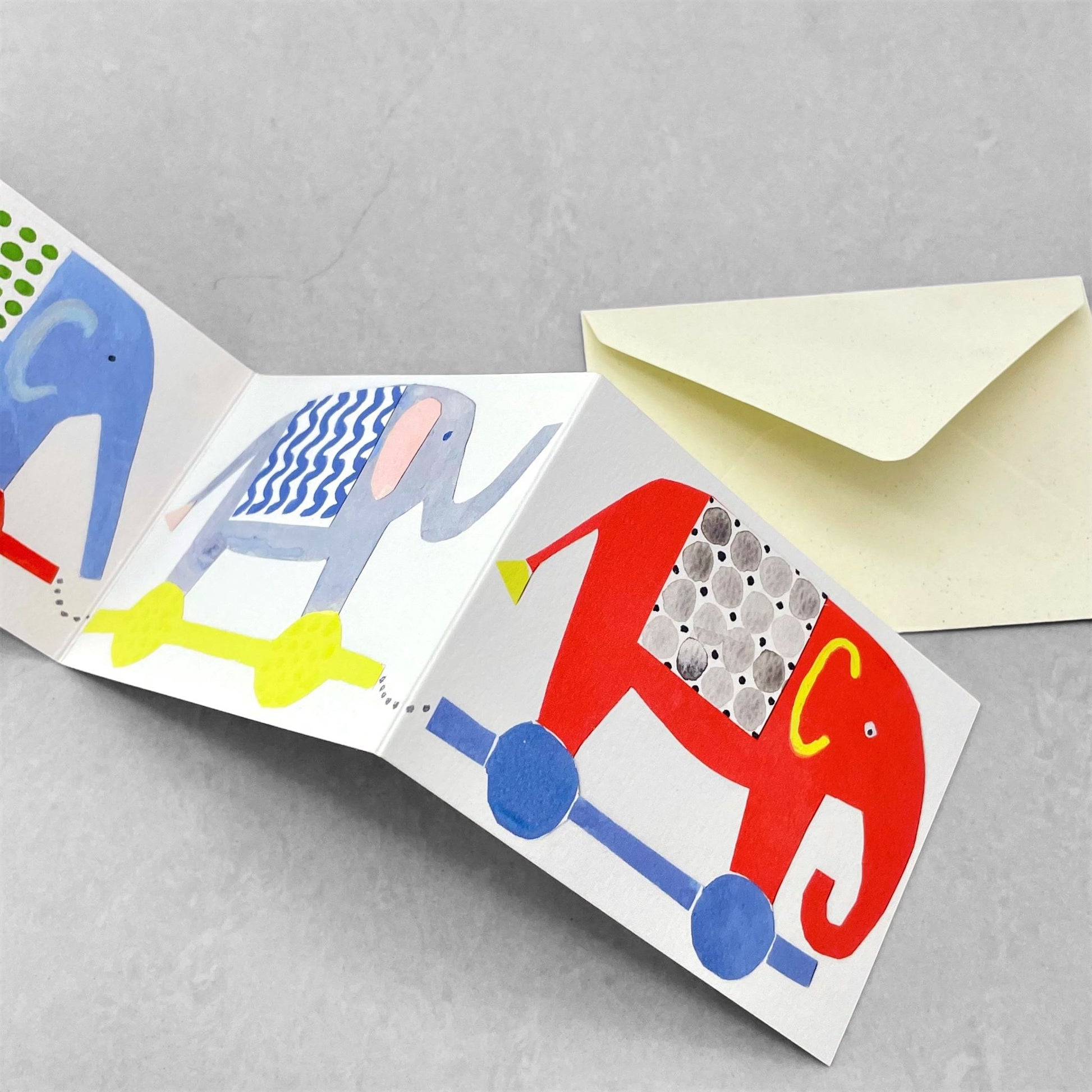 a concertina greetings card of four colourful elephants, by Hadley Paper Goods