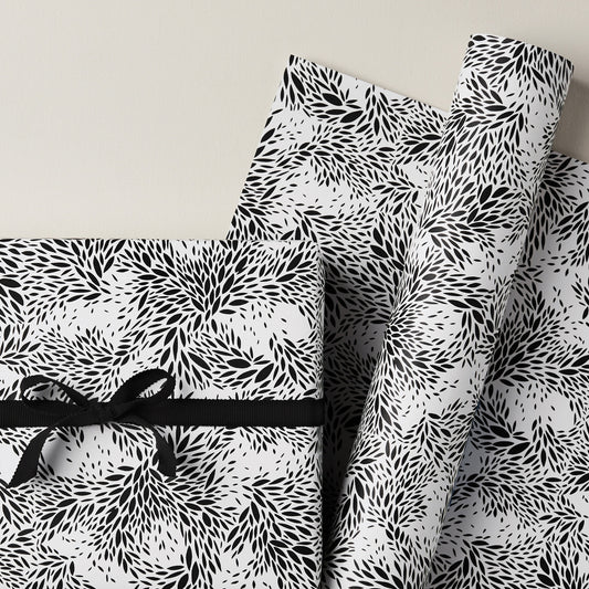 a sheet of wrapping paper with a black floral design on white