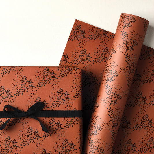 a sheet of brown wrapping paper with an abstract floral pattern in black