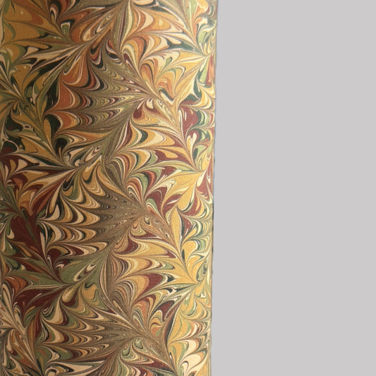 printed marbled wrapping paper by Jemma Lewis with a marbled pattern in brown, green and yellow autumnal tones. close up