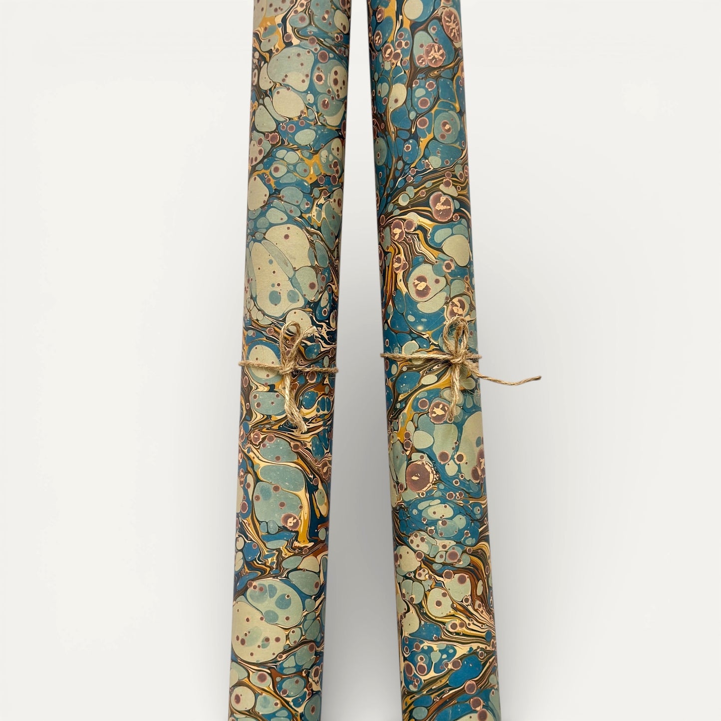 printed marbled wrapping paper by Jemma Lewis with a marbled pattern in blue, yellow, brown and cream. Rolled