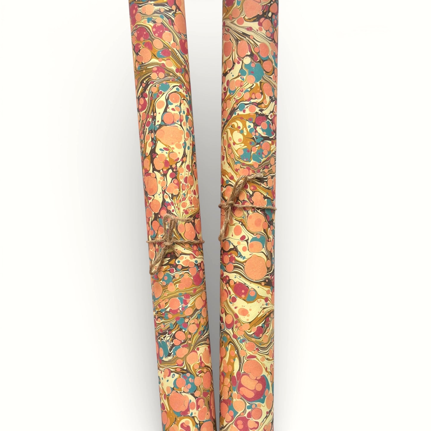 printed marbled wrapping paper by Jemma Lewis with a marbled pattern in blush pink, mustard, pale blue, brown and raspberry. Rolled