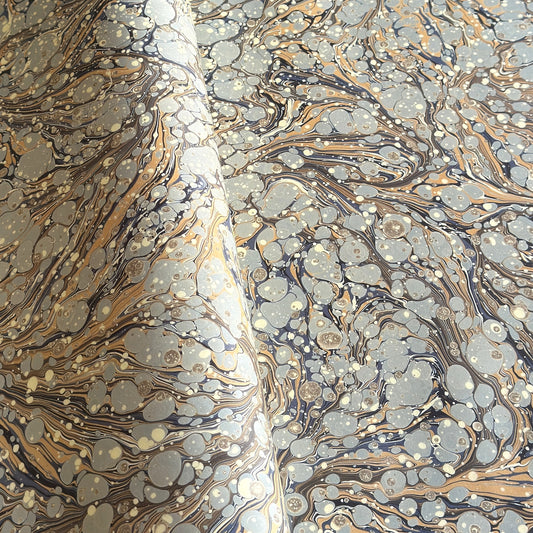 Printed marbled wrapping paper by Jemma Lewis Marbling. Marbled paper in earth tones of brown, sand, grey and soft blue.