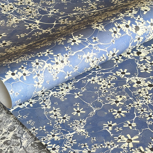 printed marble design wrapping paper by Jemma Lewis. Daisy flower design in white and black on blue backdrop