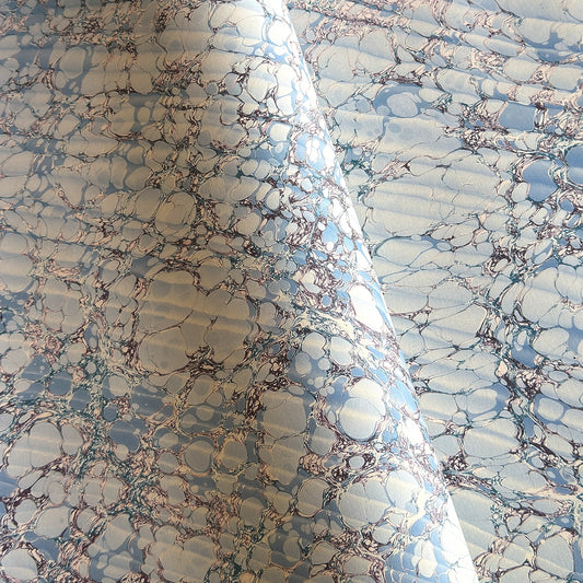 sheet of printed marbled wrapping paper by Jemma Lewis, stone effect in tones of pale blue