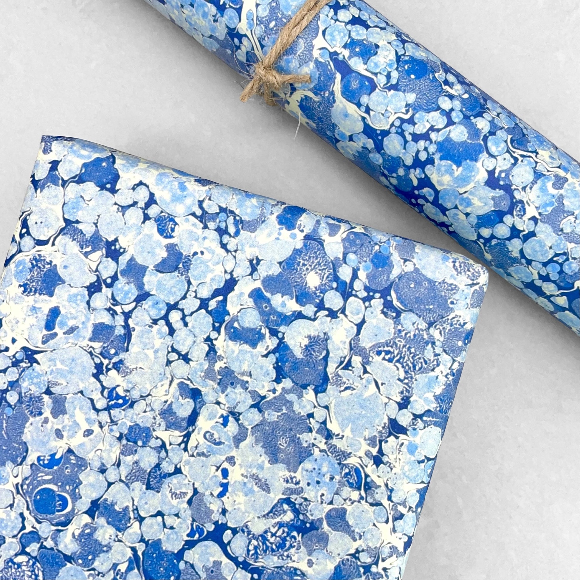 Printed marbled wrapping paper by Jemma Lewis Marbling. Marbled paper in blue and white