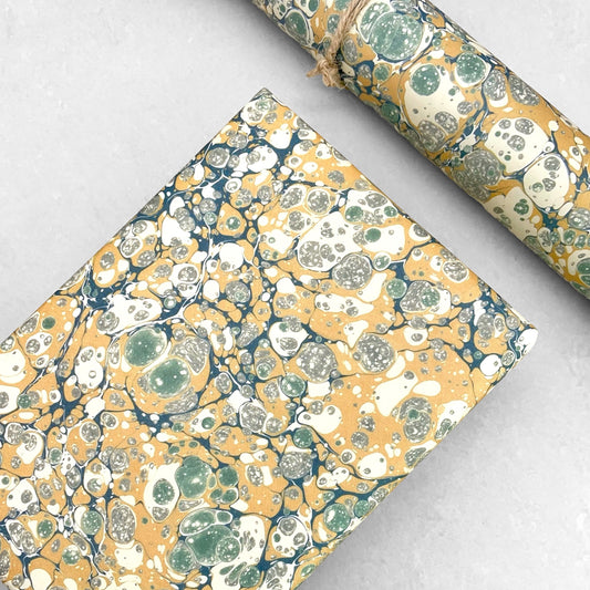 Printed marbled wrapping paper by Jemma Lewis Marbling. Marbled paper in soft greens, teal and yellow