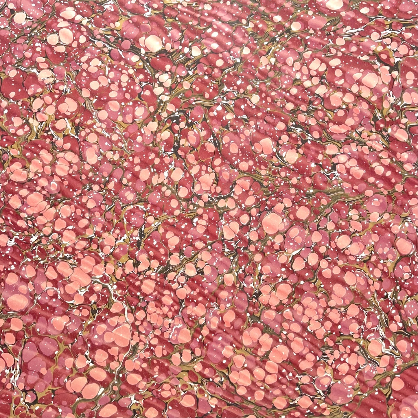 Printed marbled wrapping paper by Jemma Lewis Marbling. Marbled paper in deep burgundy, pinks and brown